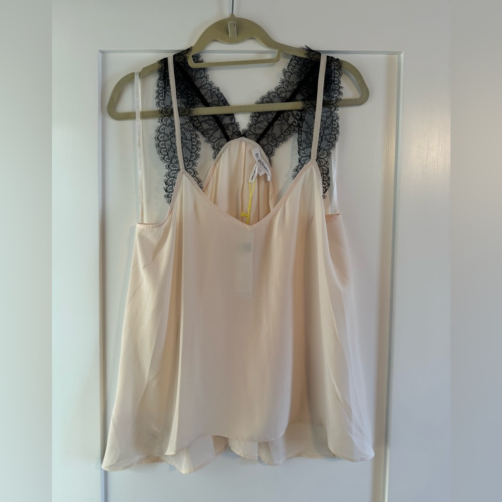 Petal pink BCBG Generation tank top featuring black scalloped lace straps.